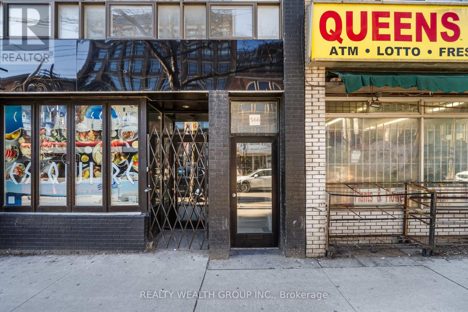A Queens ATM, Lotto, and Fresh storefront on a city street.