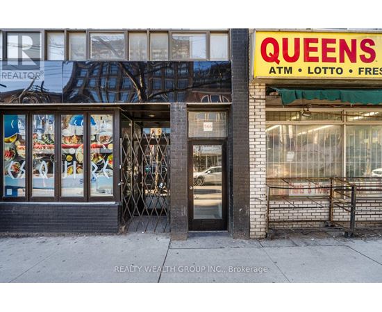 A Queens ATM, Lotto, and Fresh storefront on a city street.