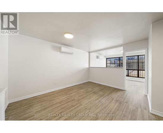 A room with a window and a door leading to a balcony.