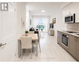 A modern kitchen and dining area with a view of the city.