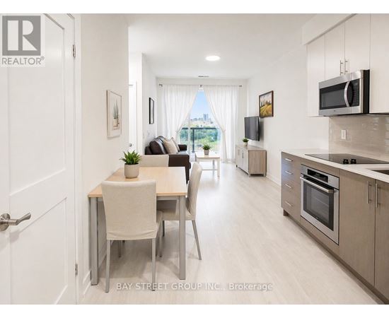 A modern kitchen and dining area with a view of the city.
