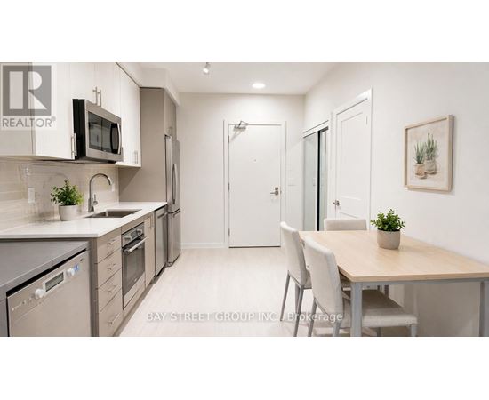 A modern kitchen with a dining table and chairs.