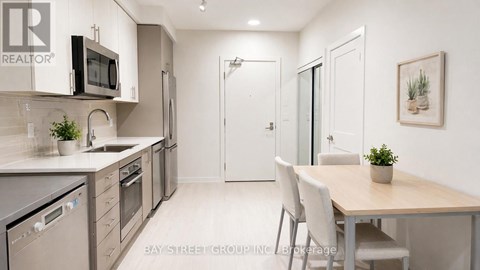 A modern kitchen with a dining table and chairs.