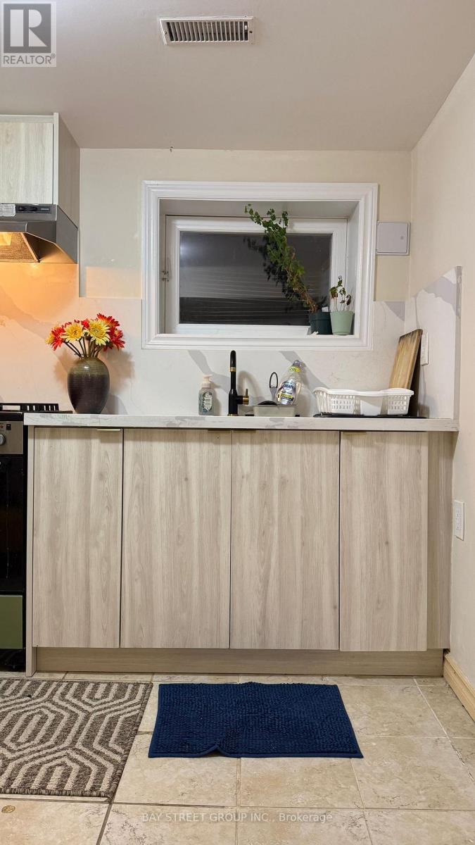 A kitchen with a wooden counter and a window.