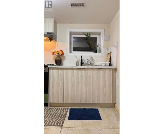 A kitchen with a wooden counter and a window.