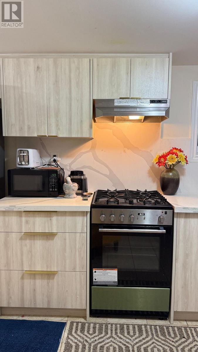A kitchen with a stove and oven built into the counter.