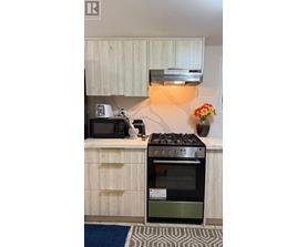 A kitchen with a stove and oven built into the counter.