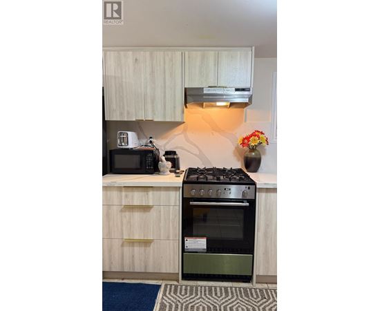 A kitchen with a stove and oven built into the counter.