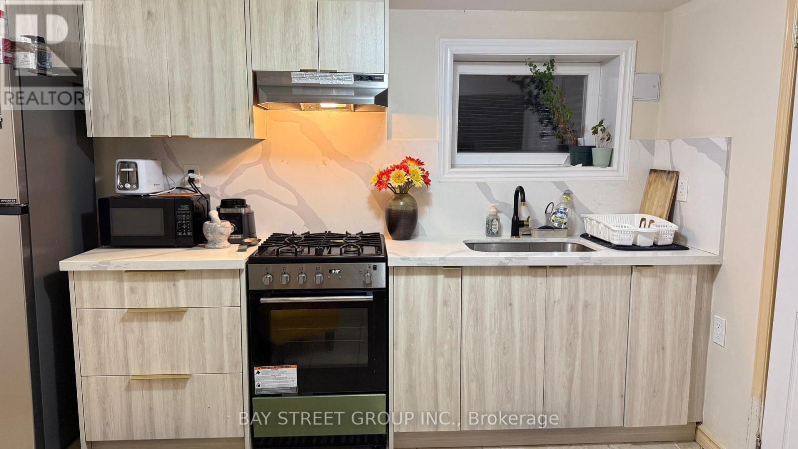 A kitchen with a stove, microwave, and oven.