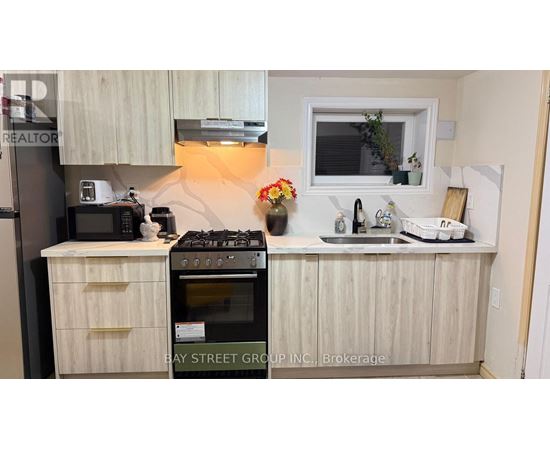 A kitchen with a stove, microwave, and oven.