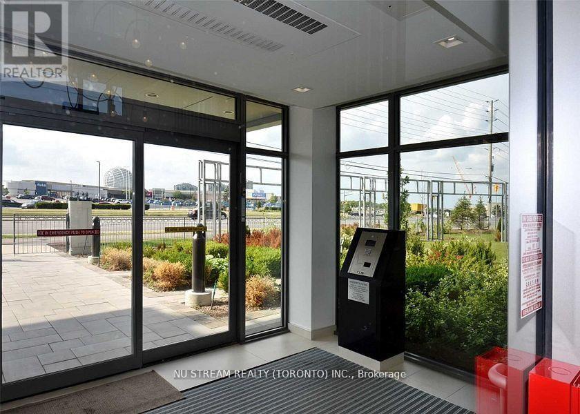 The image shows the entrance to a building with a glass door and a sign that reads "NU STREAM REALTY (TORONTO) INC., Brokerage".