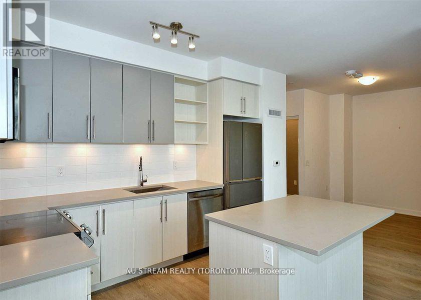 A kitchen with white cabinets and a countertop.