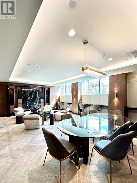 A modern living room with a glass table and chairs.