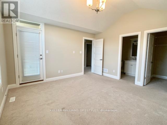 A spacious room with a sliding door and a chandelier.