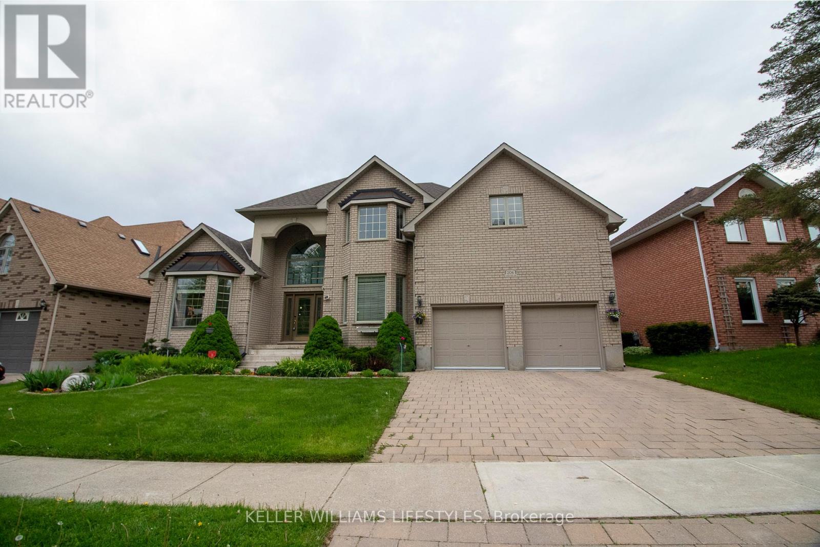 A large house with a driveway in front of it.