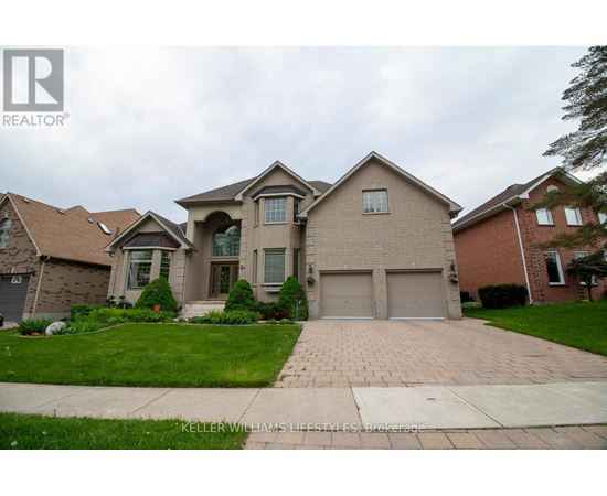 A large house with a driveway in front of it.