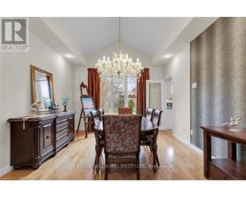 A dining room with a wooden table and chairs.