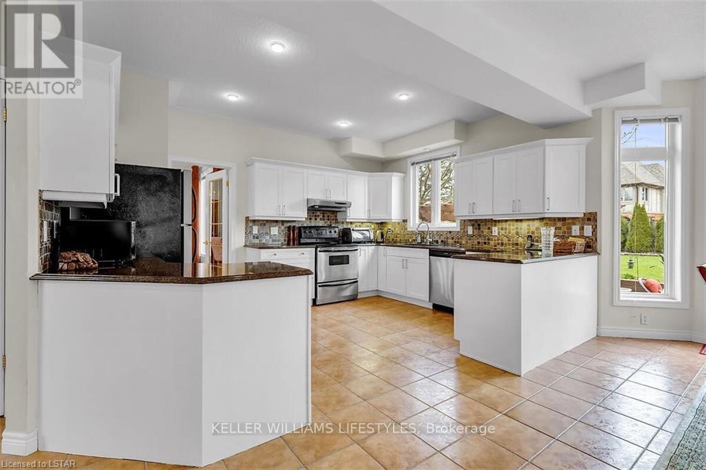 A modern kitchen with white cabinets and a central island.