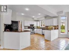 A modern kitchen with white cabinets and a central island.