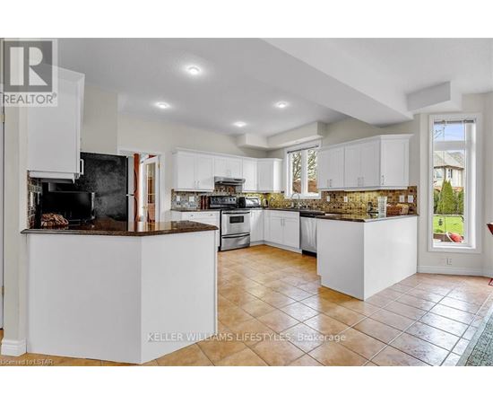 A modern kitchen with white cabinets and a central island.