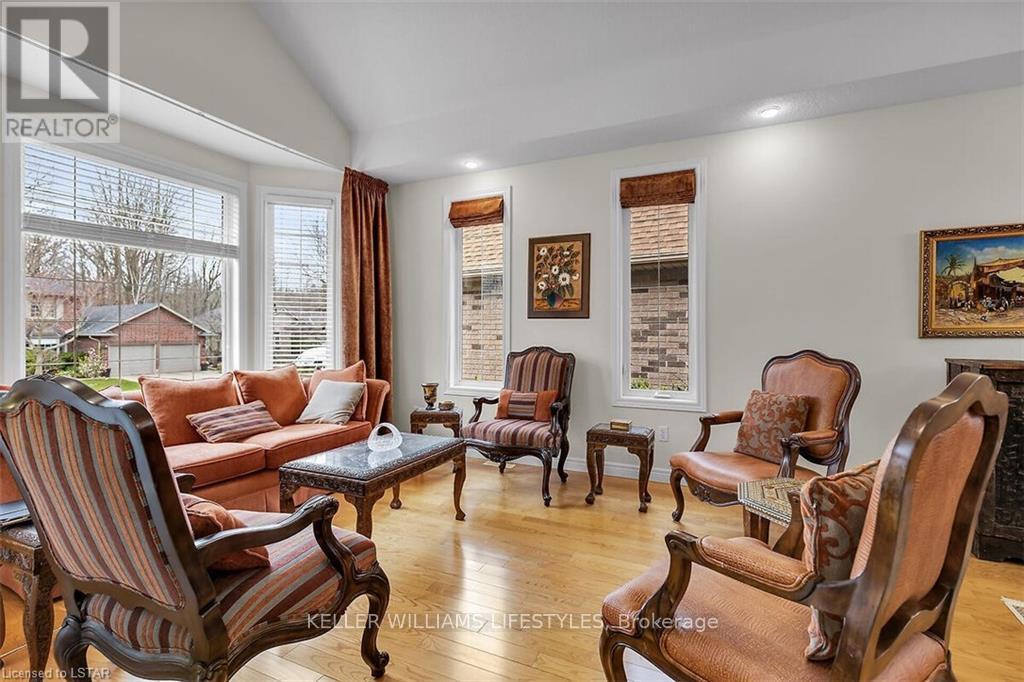 A living room with wooden furniture and a large window.