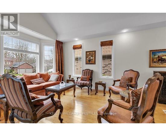 A living room with wooden furniture and a large window.