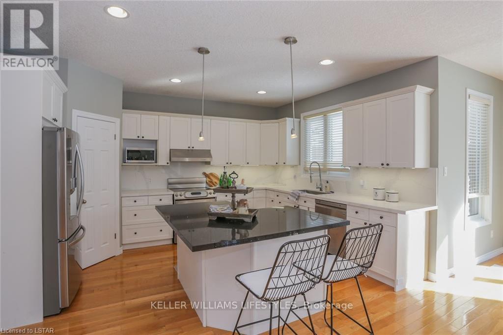 A modern kitchen with white cabinets and a black island.
