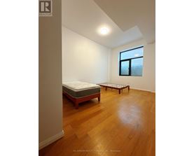 A bedroom with a bed and a bench in it.