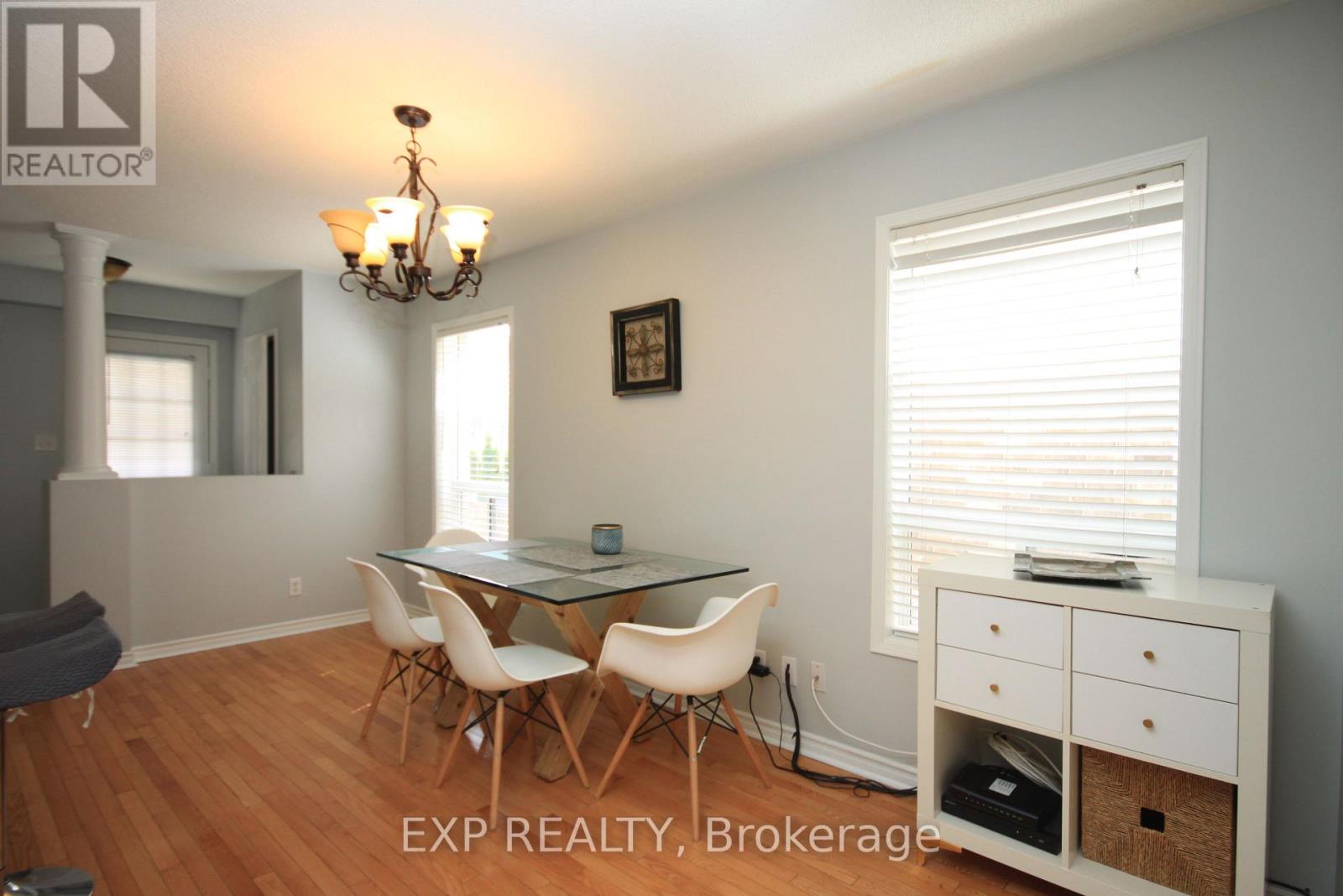 A dining room with a glass table and chairs.