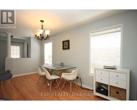 A dining room with a glass table and chairs.