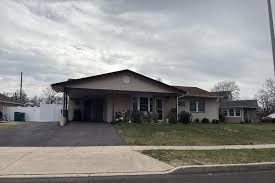 A house with a driveway in front.