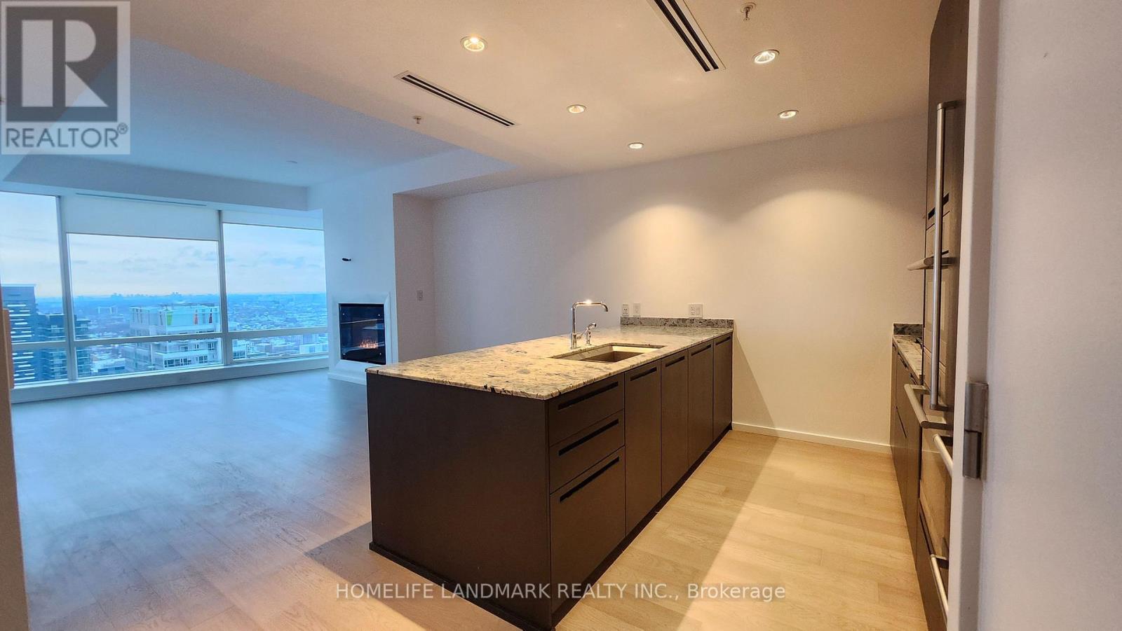 A well-lit kitchen with wooden cabinets and a large island.