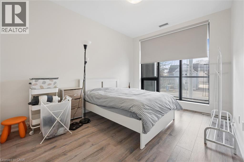A bedroom with a bed, a chair, and a small table.