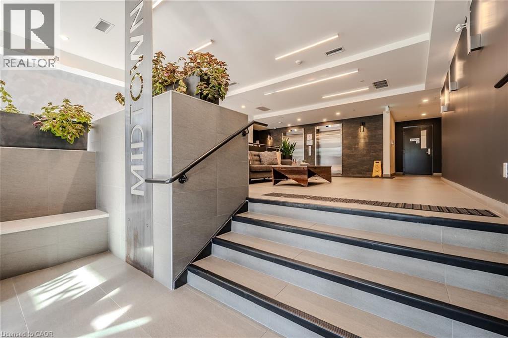 A modern interior space with a staircase leading to the second floor.