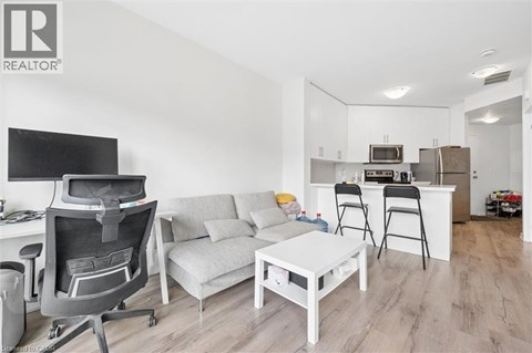 A modern living room with a grey sofa and a white coffee table.