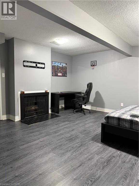 A bedroom with a fireplace and a chair.