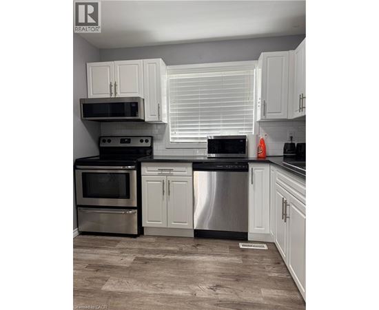 A kitchen with white cabinets and stainless steel appliances.