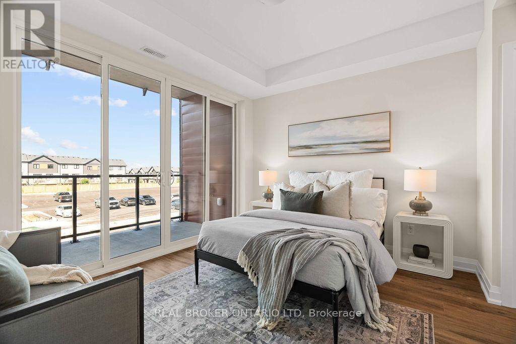A bedroom with a large bed and a view of a parking lot outside.