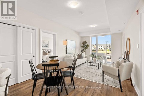 A well-lit, spacious living room with a dining table and chairs.