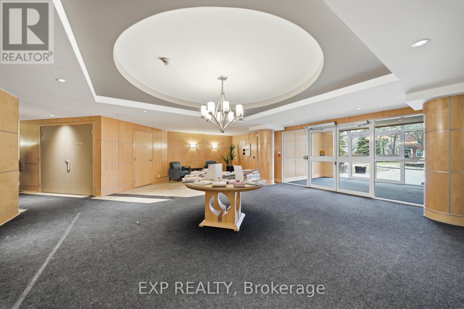 A spacious office room with a table and chairs in the center.