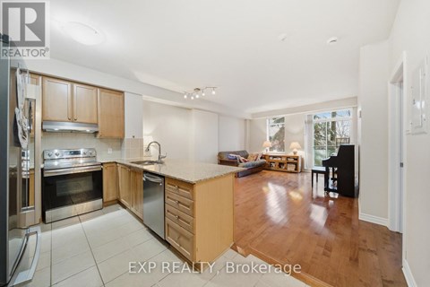 A kitchen with wooden cabinets and a stainless steel oven.
