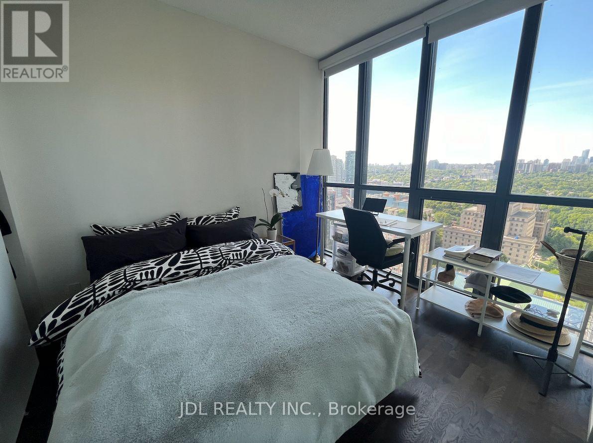 A bedroom with a large bed and a view of the city.