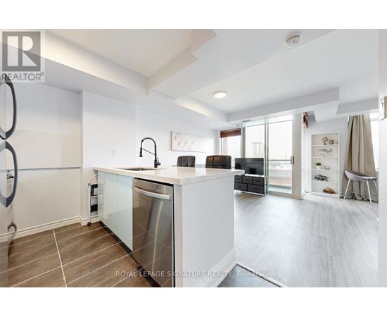 A modern kitchen with a large island and stainless steel appliances.