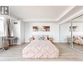 A bedroom with a large bed and a mirror on the wall.