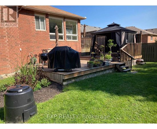 A backyard with a deck and a gazebo.