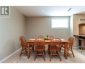 A dining room with a table and chairs.