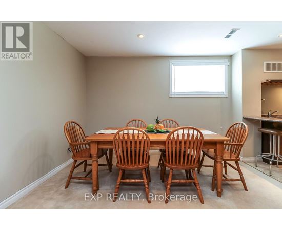 A dining room with a table and chairs.