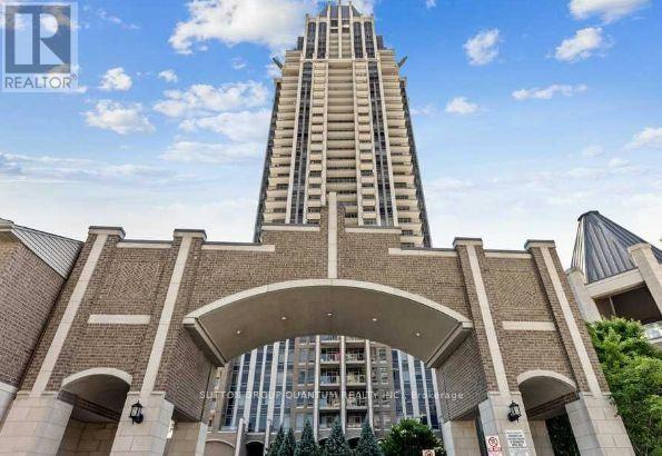 A tall building with a curved entrance and a sign that says REALTOR.