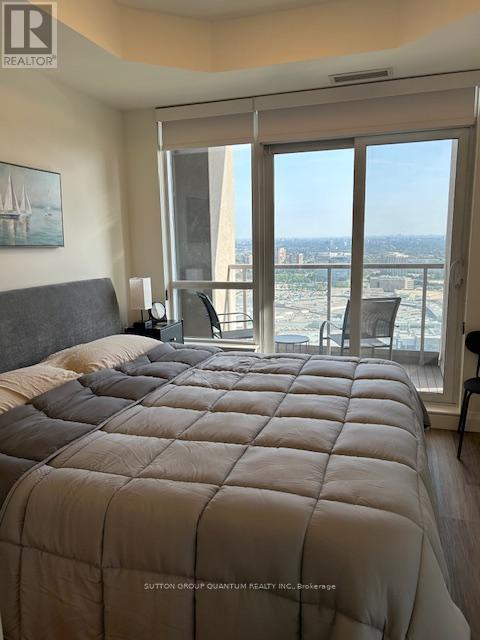 A bedroom with a large bed and a view of the city.