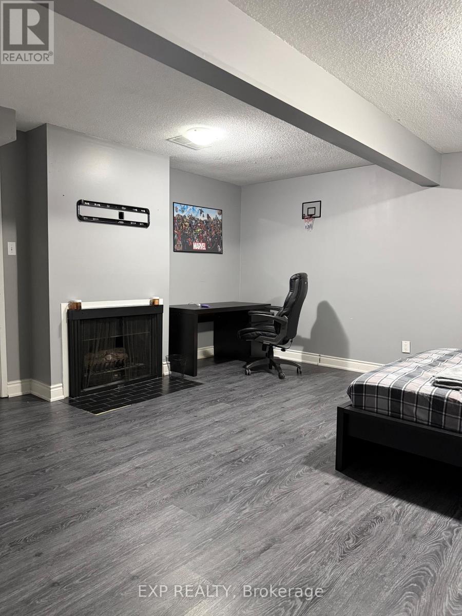 A bedroom with a fireplace and a bed.